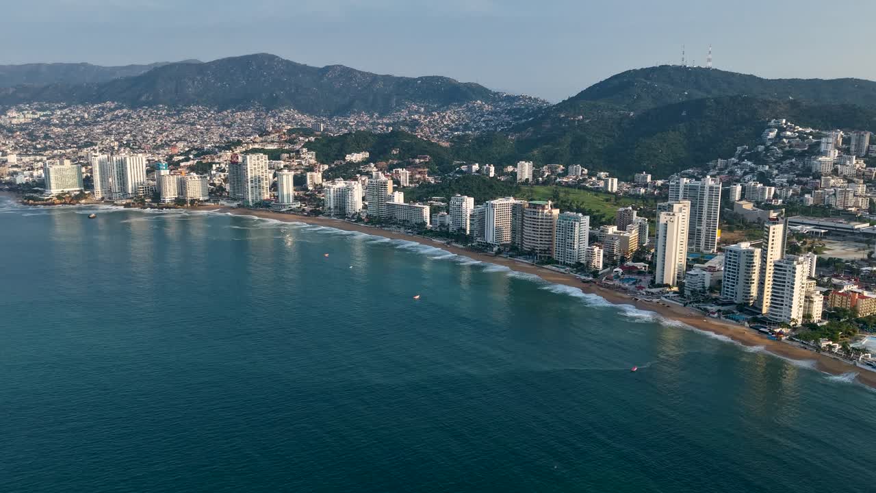 Hyperlapse drone view of Acapulco Bay under morning sunlight, Mexico