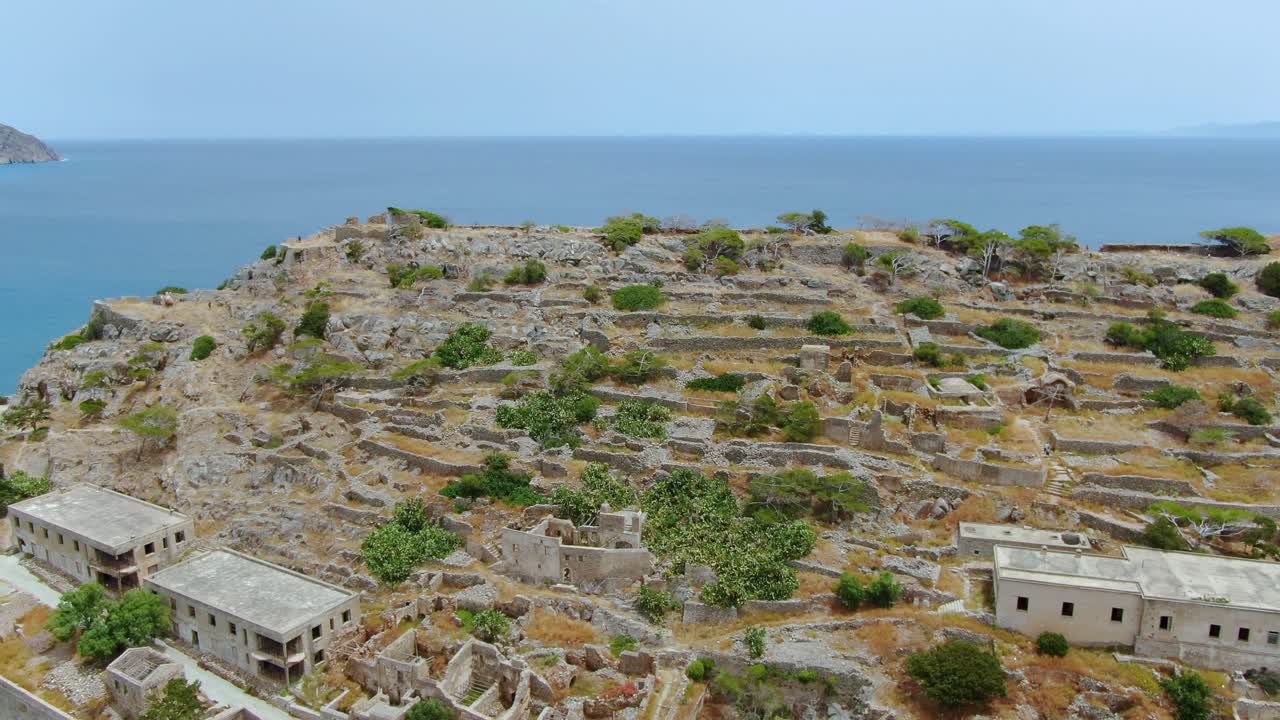 aerial reveal of house ruins and fortress walls of Spinalonga, Crete, Lashiti