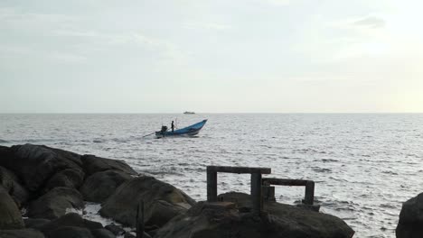 Solitary-boatman-standing-over-his-boat-as-it-cruises-over-the-waters-in-Koh-Phangan-District-Surat-Thani-Thailand