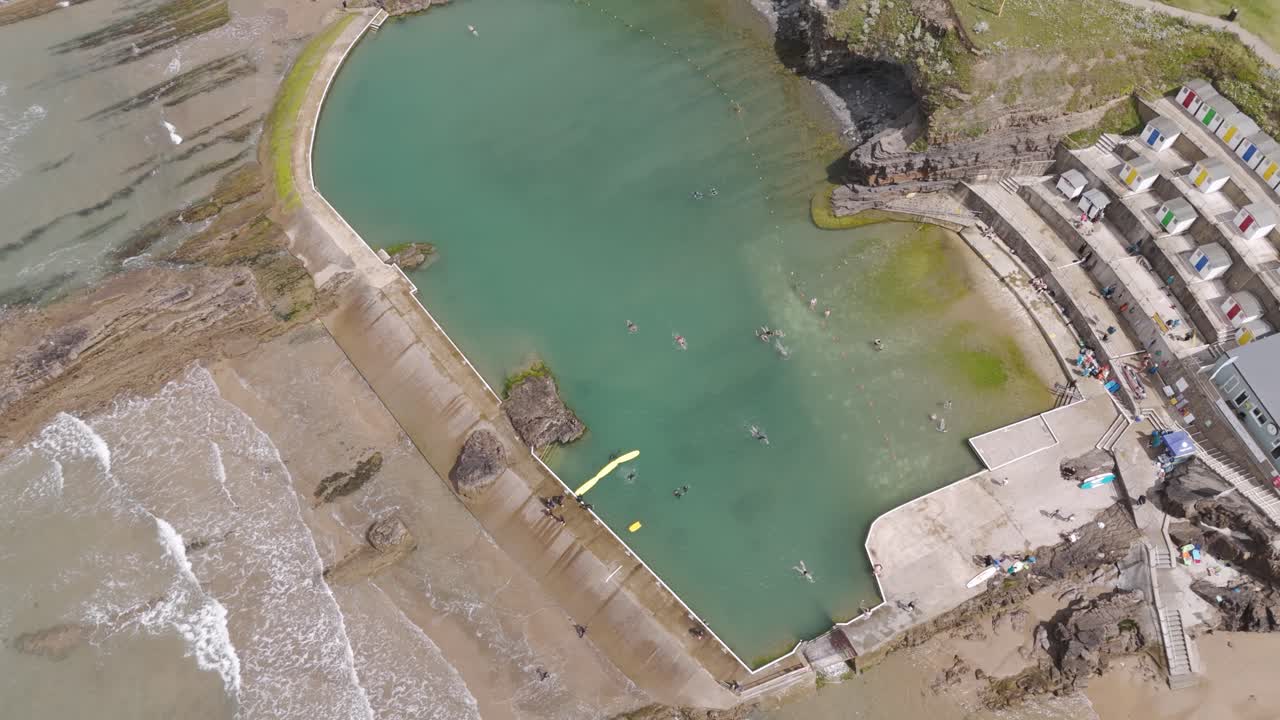 Aerial View of a Coastal Sea Pool and Beach with Swimmers
