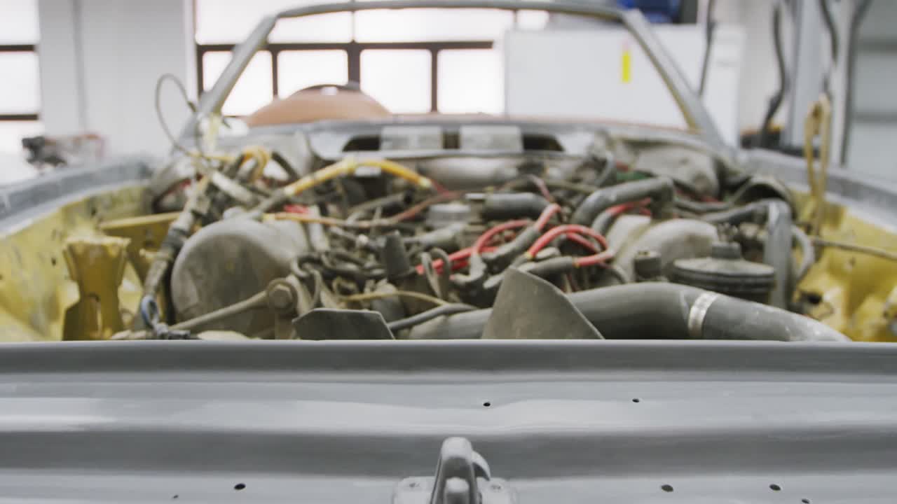 Open car engine standing in a township workshop being prepared to be repaired