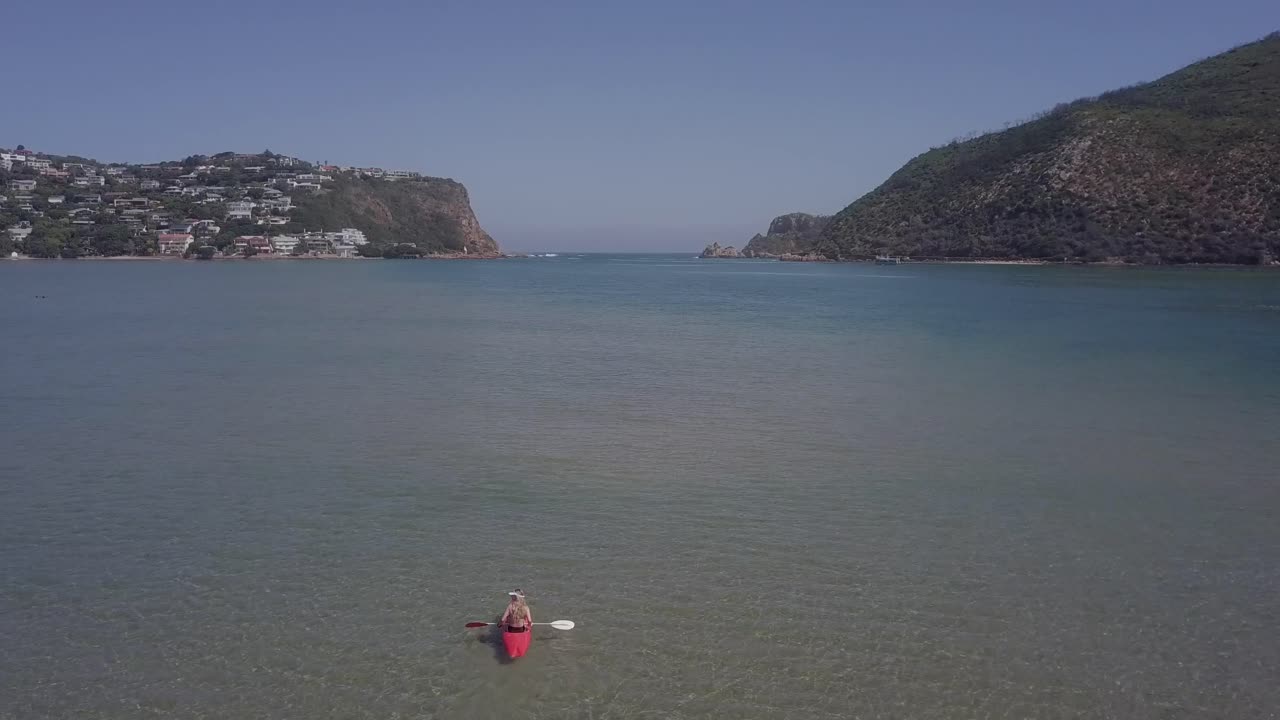 Kayakers enjoy sunny day in Knysna Lagoon, Knysna Heads seen beyond