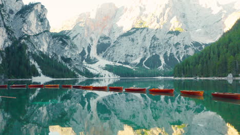 Dramatic-reveal-of-the-Prag-Dolomites-reflected-in-the-pristine-waters-of-Lake-Braies,-Tyrol-Italy,-aerial