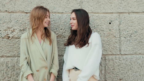 two women laughing outdoors