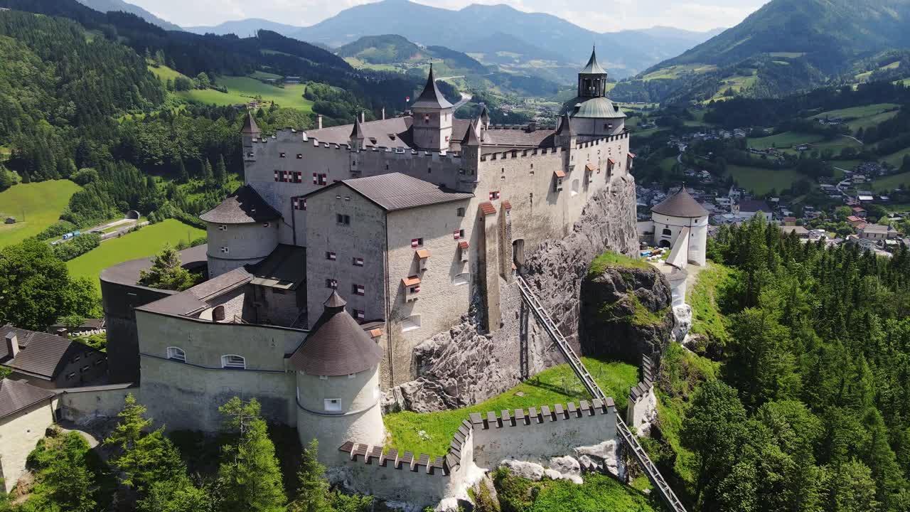Historic Hohenwerfen Castle on forested hilltop, dramatic alpine scenery, 4k
