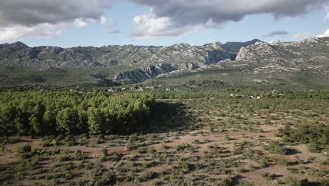 Hermosa-Costa-De-Piedra-De-Un-Océano-Con-Grandes-Montañas-Al-Fondo-En-La-Hora-Dorada