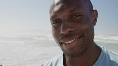 Male-volunteer-looking-at-camera-on-the-beach-4k