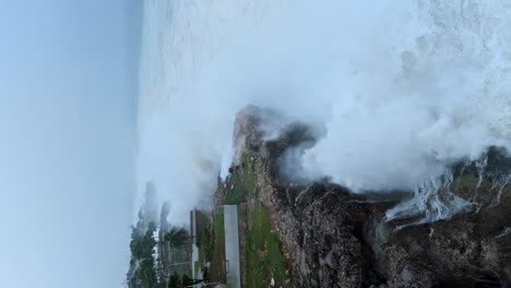 Rocky-coastline-with-huge-storm-waves,-hurricane-in-the-Caribbean,-aerial-orbit