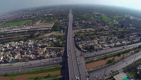 aerial view over the city traffic road junction and canal, bridge highway