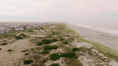 Sunset-on-the-beach-over-sea-overlooking-dunes-and-vacation-homes