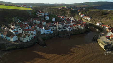 establishing drone shot over staithes coastal village on sunny day uk