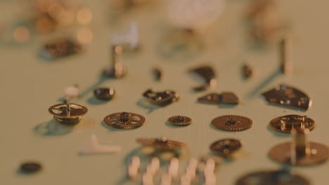 Macro-Of-Intricate-Parts-Of-A-Gold-Watch-Lying-On-A-Flat-Surface