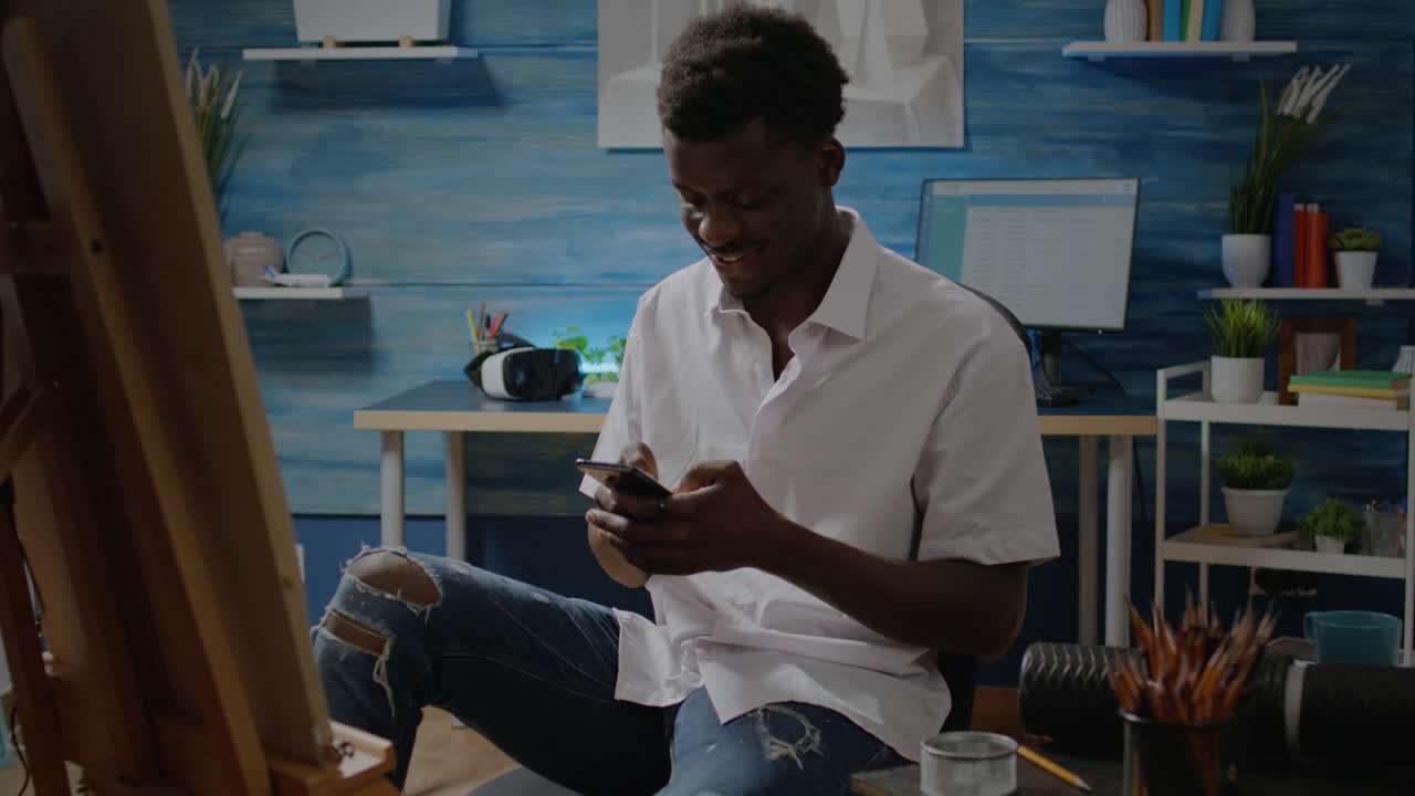 African american adult using smartphone for drawing process