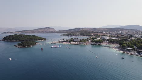 Aerial-over-Ksamil-Islands-and-nearby-resorts-on-the-coastline,-Albania