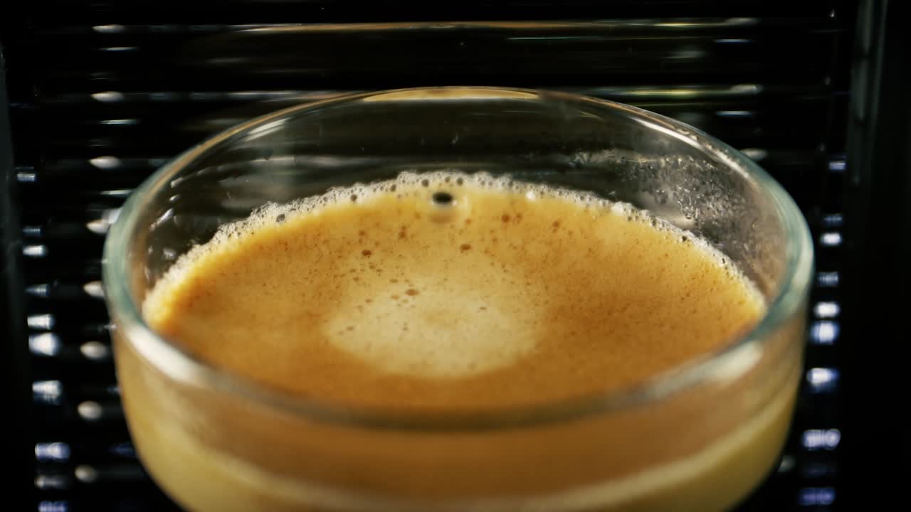 Hot And Creamy Espresso In A Clear Glass - Closeup Shot