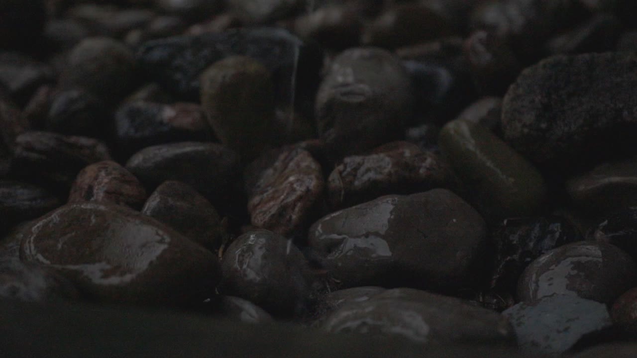 Close Up Of A Small Stone With Rain Drops - Close Up Shot