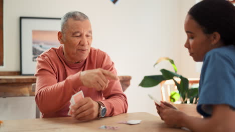 Woman,-nurse-and-senior-patient-playing-cards