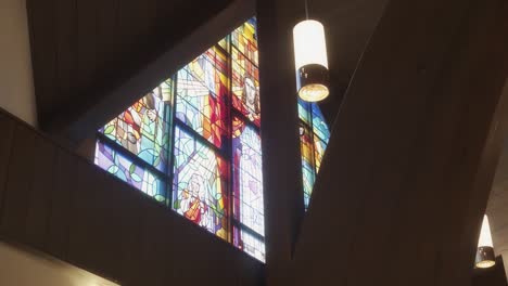 stained glass design of jesus christ on a catholic church steeple window