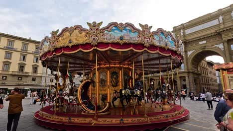 a carousel spinning in a busy square