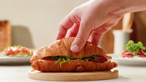 croissant sandwich being prepared