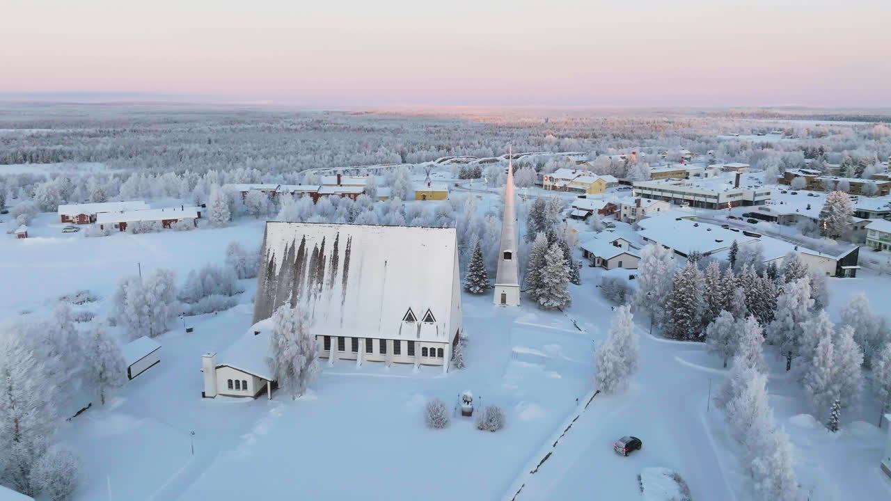 Aerial view rotating toward the frosty church of Salla, polar night n Lapland