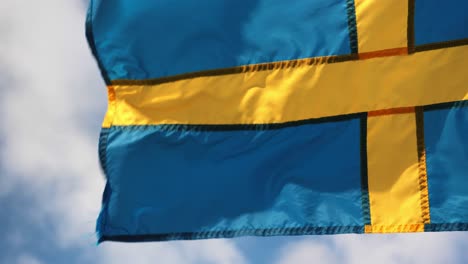 swedish flag waving in the sky with clouds and wind in gothenburg city