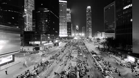 black and white timelapse of hong kong political protest, student protest blocking queens' road central in hong kong.