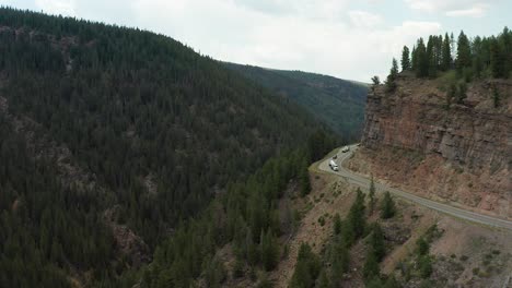 A-tanker-truck-and-cars-are-navigating-a-cliff-side-road-in-the-Rocky-Mountains-Colorado