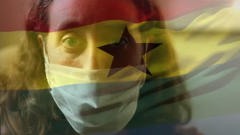 Ghana-flag-waving-against-woman-wearing-face-mask