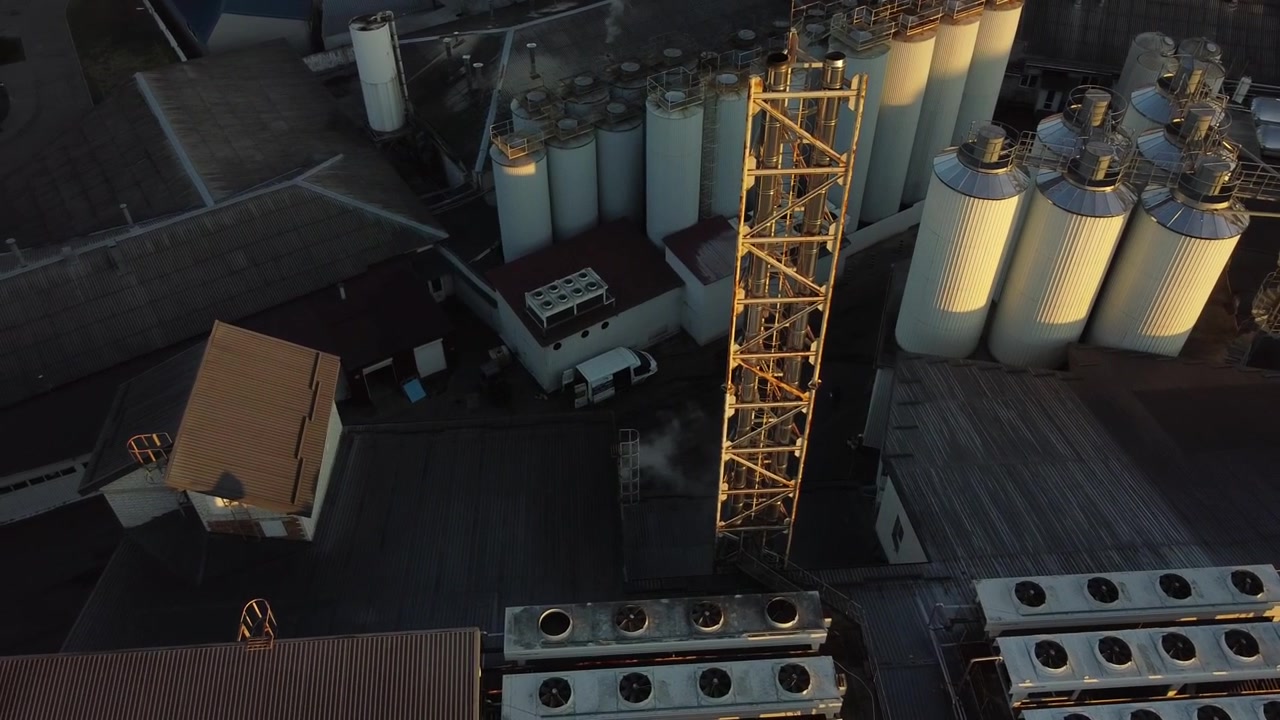 Aerial view of a drone flying over the beer production plant, several rows of tanks.