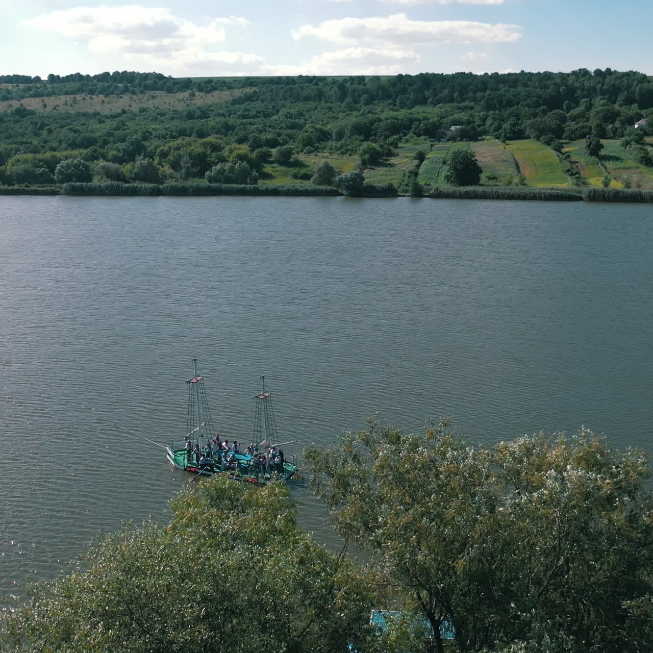 Old boat floating in the river background. Boat trip along the river. Aerial view. Camera moves down.