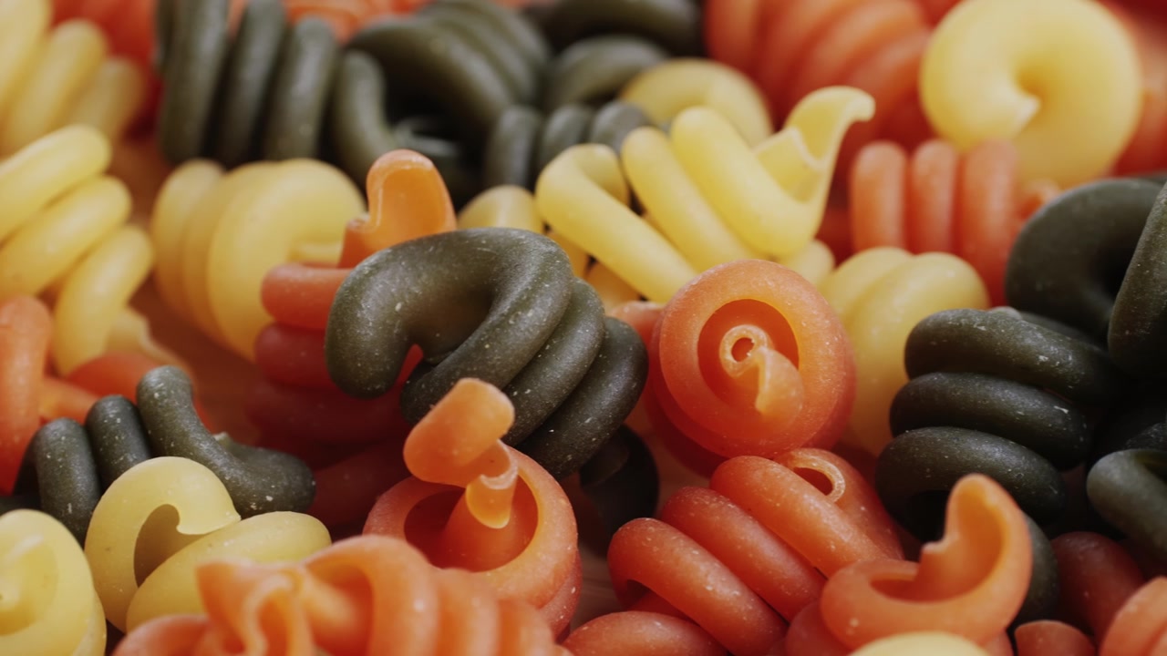 Close-up of Uncooked Colorful Tricolor Fusilli Pasta