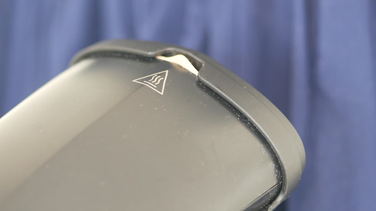 Close-up of an appliance with a hot surface warning