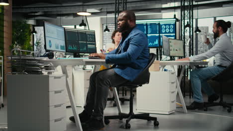 vertical video african american male analyzing financial data forecast on a computer,