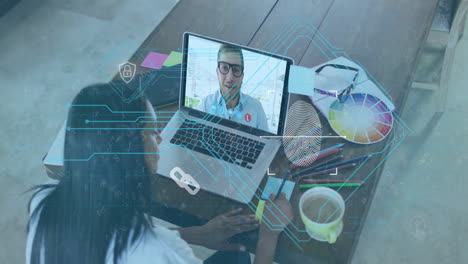 digital interface animation over person video conferencing on laptop at desk