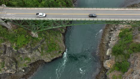 overhead drone shot of cars commuting over the deception pass steel bridge