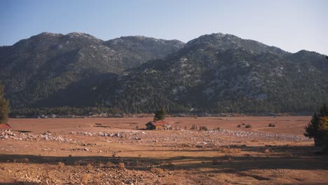 establisher wide view of peaceful countryside valley with hut and livestock, turkey, ibradi, antalya nature adventure