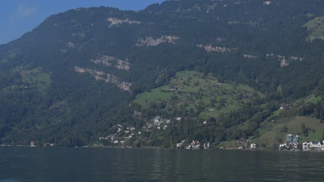 shoreline towns and mountains from lake lucerne switzerland ferry view