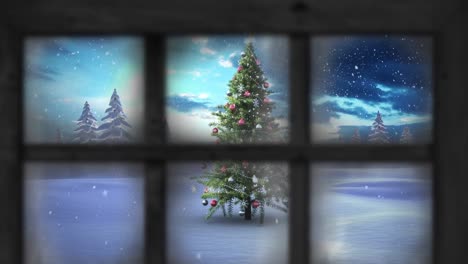animación de nieve cayendo sobre el árbol de navidad y paisaje de invierno visto a través de la ventana