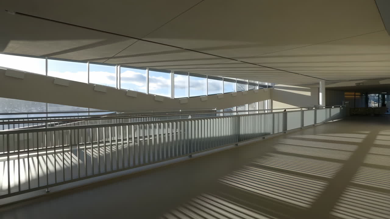 Modern architectural interior with sunlit ramp, staircase, and geometric shadows