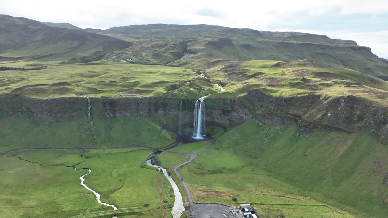 enormes acantilados verdes con la cascada de seljalandsfoss en el sur de islandia