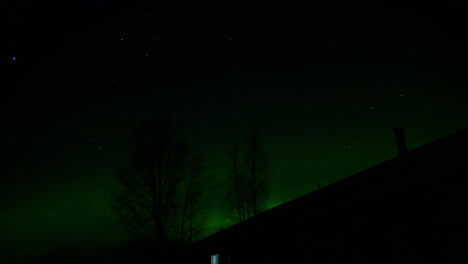 Northern-Lights,-Aurora-Borealis-Polar-lights-above-house-in-Finland-at-night,-Time-lapse