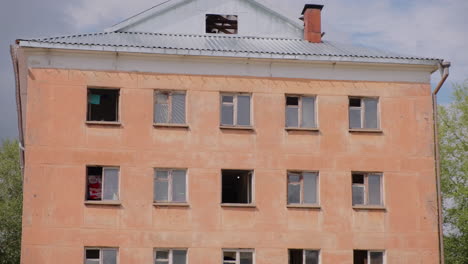 old multi-story building with broken windows