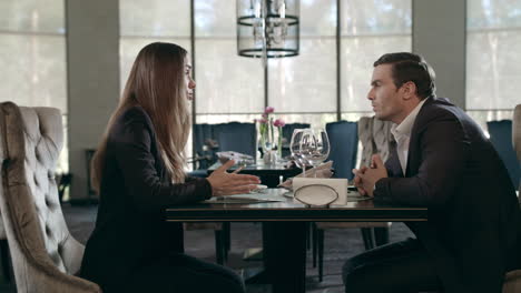 business couple talking at restaurant. business man and woman meeting in cafe