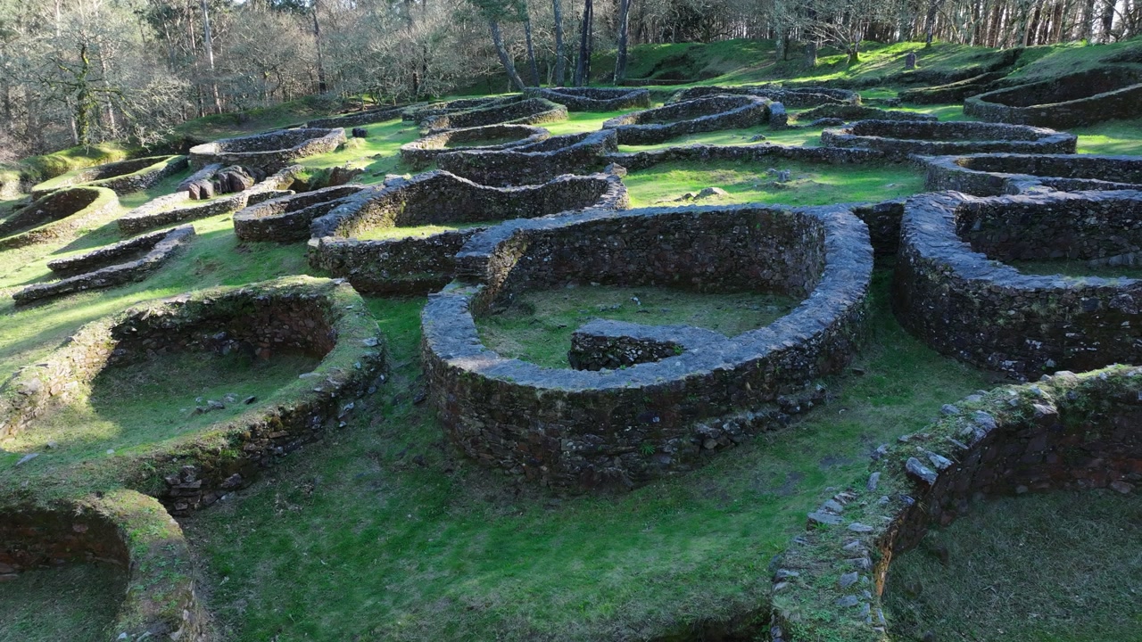 Ancient Circular Stone Foundations At Castro De Borneiro Culture Settlement In Galicia, Spain. close-up drone shot