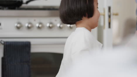happy asian family dancing in kitchen father enjoying dance with daughter little girl laughing enjoying exciting weekend at home 4k footage