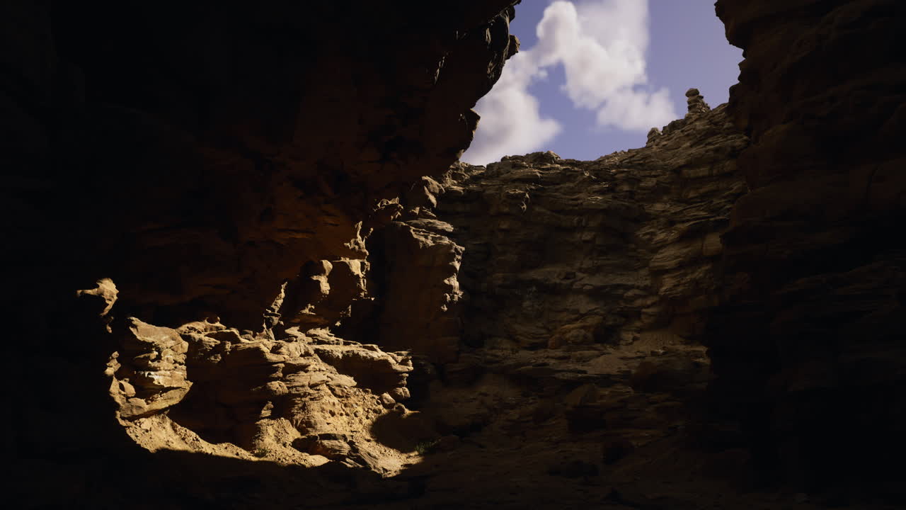 Exploring a rocky cavern with natural light illuminating the contours