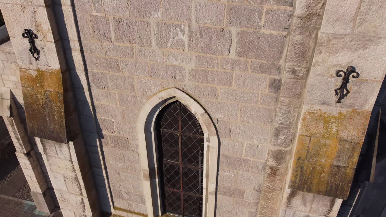 Rise aerial close up shot of a church in the countryside of Vionnaz, Switzerland on a sunny day.
