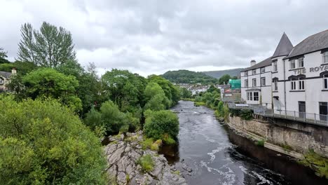 river flowing through lush greenery and buildings