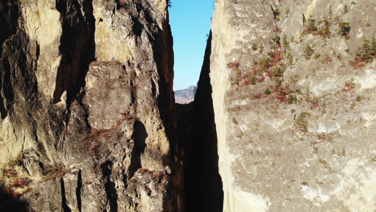 Aerial View of a Narrow Canyon with Towering Rock Walls